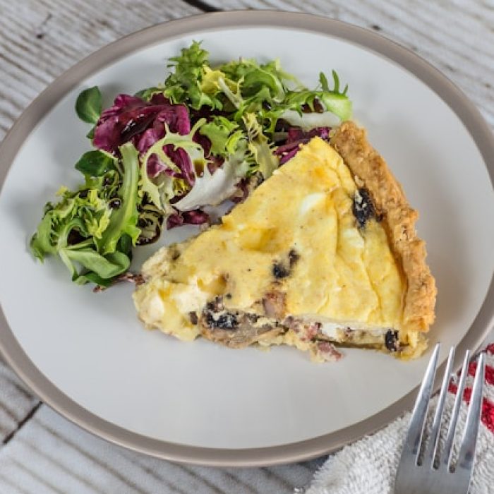 Quiche and salad on a plate.