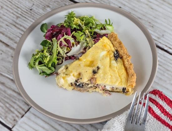 Quiche and salad on a plate.